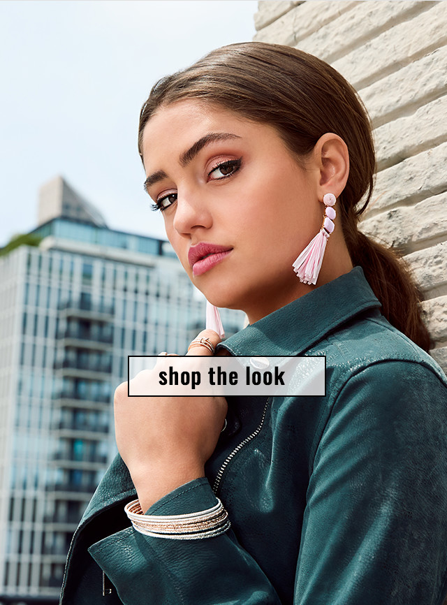 woman with bangle bracelets and tassel earrings