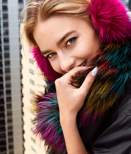 smiling woman wearing colorful winter pieces